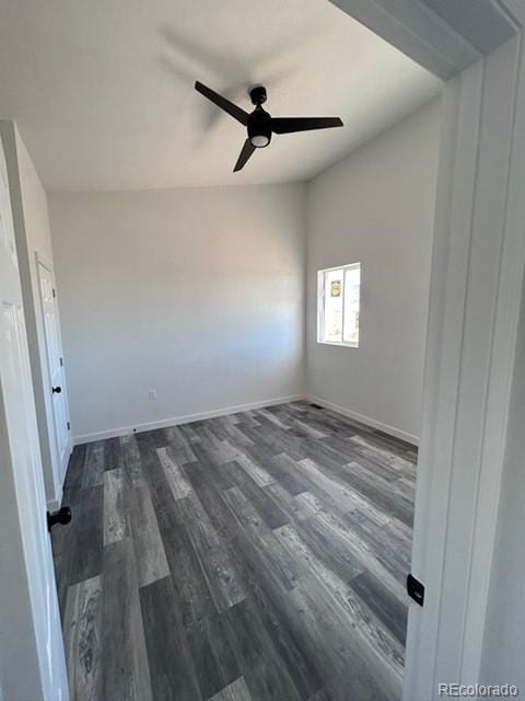 spare room featuring ceiling fan and dark wood-type flooring