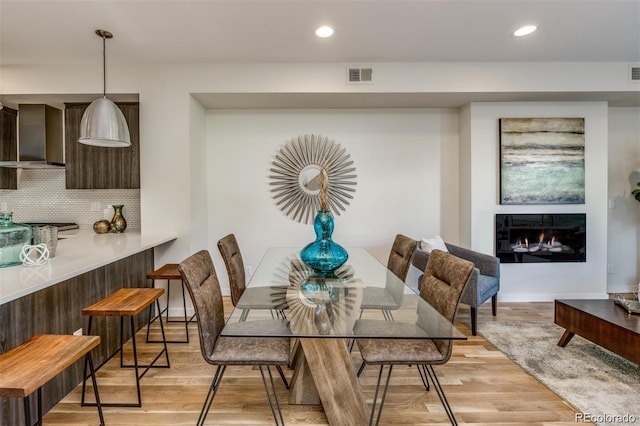 3408 W 18th Ave, Denver, CO 80204 - dining area with light wood-style flooring, recessed lighting, and a lit fireplace