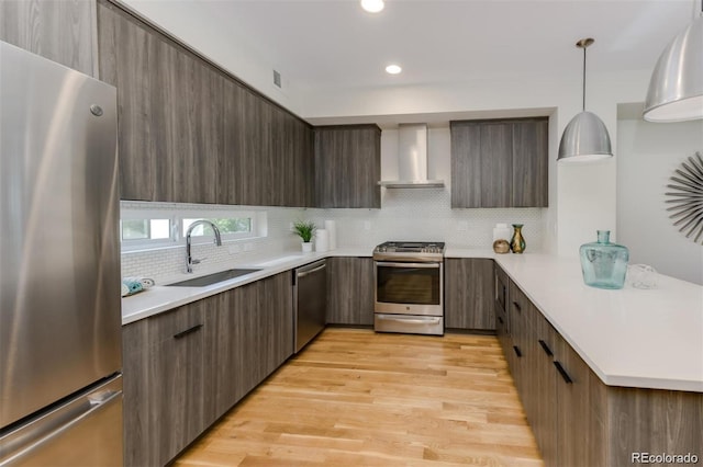 3408 W 18th Ave, Denver, CO 80204 - kitchen with stainless steel appliances, wall chimney exhaust hood, modern cabinets, light countertops, and recessed lighting