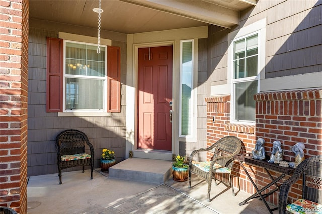 27029 E Irish Pl, Aurora, CO 80016 - view of exterior entry featuring brick siding and a porch