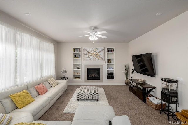 27029 E Irish Pl, Aurora, CO 80016 - living room featuring carpet floors, a ceiling fan, built in features, a fireplace, and baseboards
