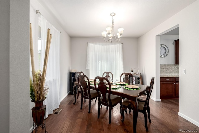 27029 E Irish Pl, Aurora, CO 80016 - dining area with a chandelier, dark wood finished floors, and baseboards