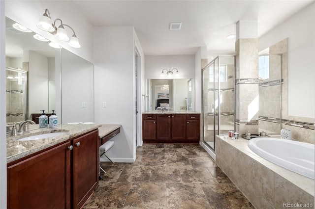 27029 E Irish Pl, Aurora, CO 80016 - bathroom featuring a stall shower, a garden tub, vanity, baseboards, and stone finish floors