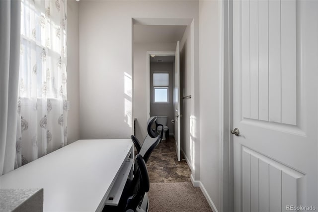 27029 E Irish Pl, Aurora, CO 80016 - hall with baseboards, dark carpet, and a desk