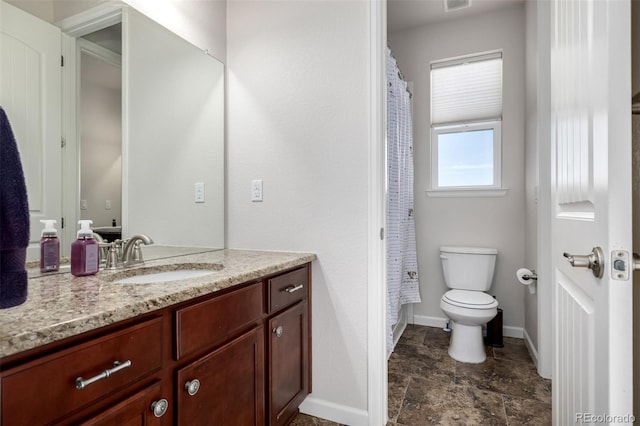 27029 E Irish Pl, Aurora, CO 80016 - full bath featuring toilet, baseboards, vanity, stone finish floors, and a shower with curtain
