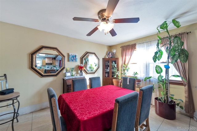 tiled dining room featuring ceiling fan