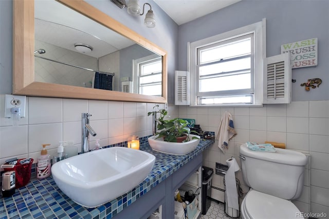 bathroom with backsplash, toilet, tile flooring, and tile walls