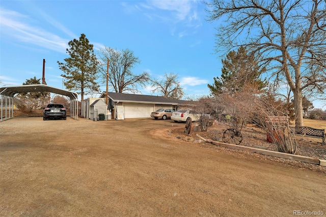 view of yard featuring a garage and a carport