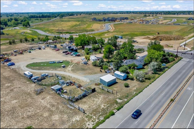 birds eye view of property with a rural view