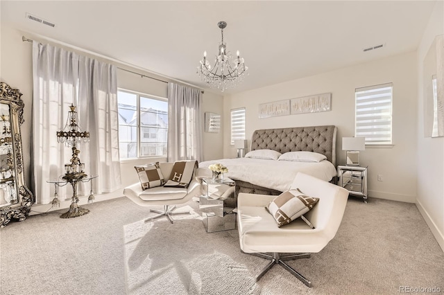 carpeted bedroom with a notable chandelier