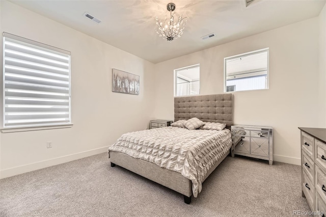 bedroom featuring light colored carpet and a notable chandelier