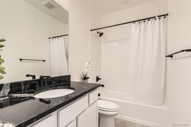 full bathroom with tile patterned floors, vanity, toilet, and shower / bath combo with shower curtain