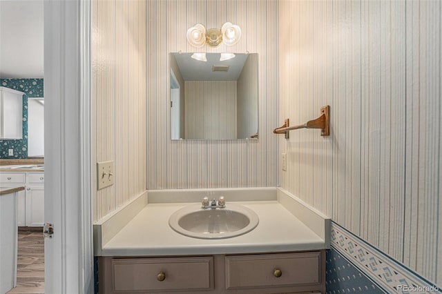 bathroom featuring hardwood / wood-style flooring and vanity