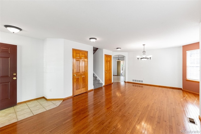 13180 Jasmine St, Thornton, CO 80602 - unfurnished room featuring a chandelier, stairs, light wood finished floors, and baseboards