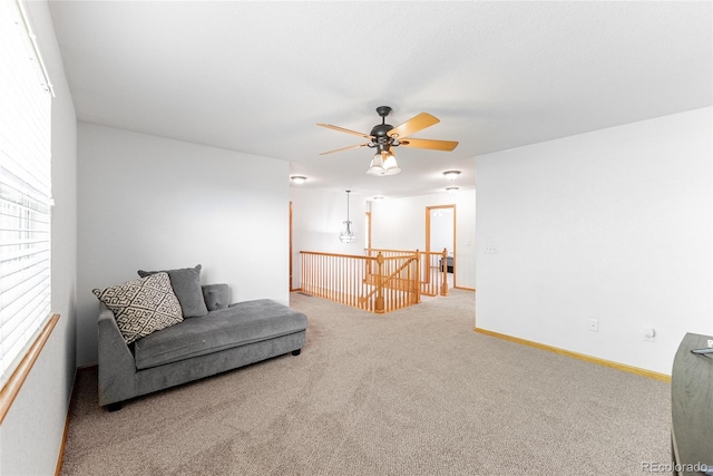 13180 Jasmine St, Thornton, CO 80602 - living area with carpet, an upstairs landing, a ceiling fan, and baseboards