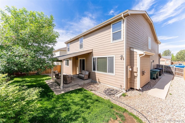 13180 Jasmine St, Thornton, CO 80602 - back of property featuring an outdoor living space and a patio area