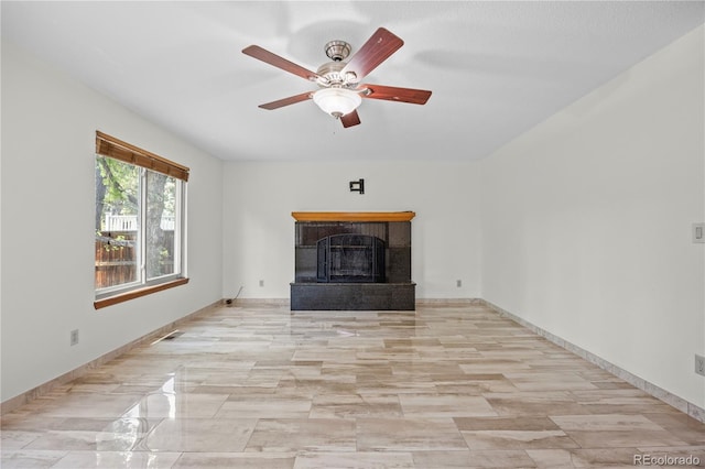 8725 Meadowlark Cir, Highlands Ranch, CO 80126 - unfurnished living room featuring a fireplace with raised hearth and a ceiling fan