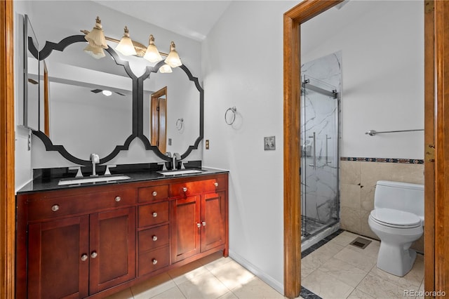 8725 Meadowlark Cir, Highlands Ranch, CO 80126 - full bath with a marble finish shower, double vanity, tile walls, and wainscoting