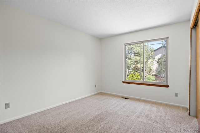 8725 Meadowlark Cir, Highlands Ranch, CO 80126 - carpeted spare room featuring baseboards and a textured ceiling