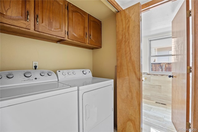 8725 Meadowlark Cir, Highlands Ranch, CO 80126 - laundry area with washing machine and clothes dryer and cabinet space