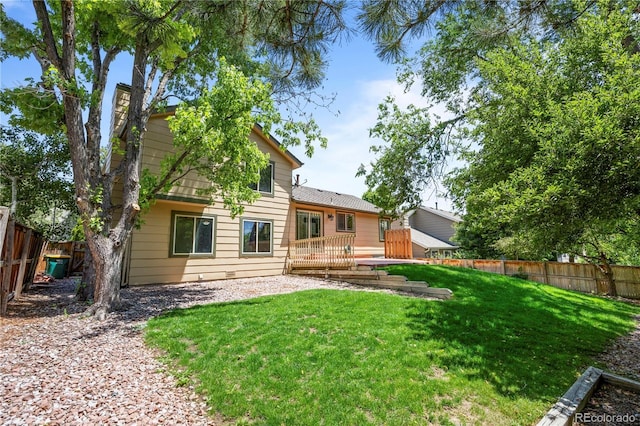 8725 Meadowlark Cir, Highlands Ranch, CO 80126 - rear view of house with a fenced backyard and a wooden deck