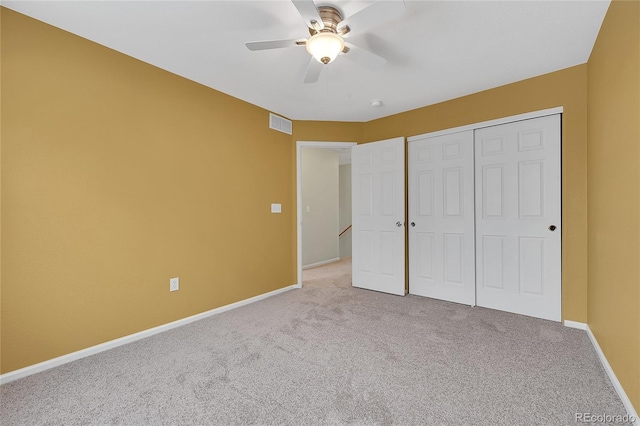 unfurnished bedroom with carpet, a closet, visible vents, and baseboards