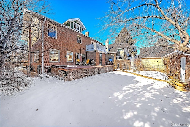 yard layered in snow featuring a balcony