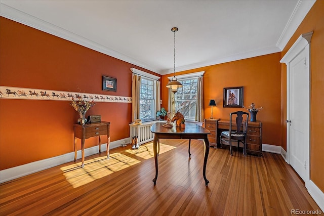 interior space with wood-type flooring, radiator, and crown molding