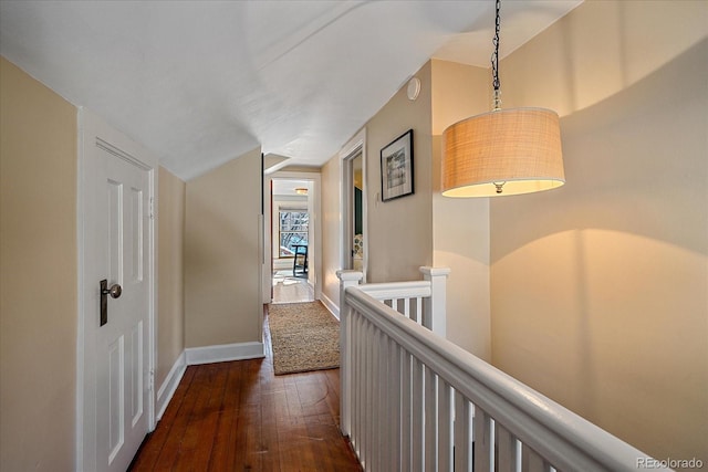 hallway featuring lofted ceiling and dark hardwood / wood-style floors