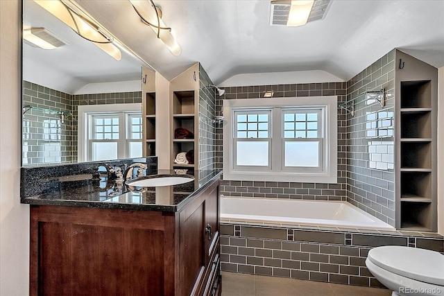 full bathroom with lofted ceiling, tiled shower / bath combo, vanity, toilet, and tile patterned floors