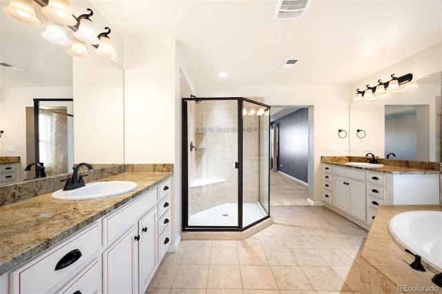 bathroom with tile patterned flooring, shower with separate bathtub, and vanity