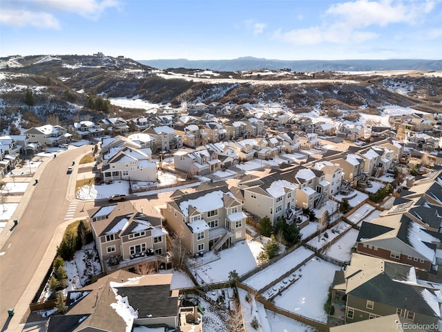 snowy aerial view with a mountain view