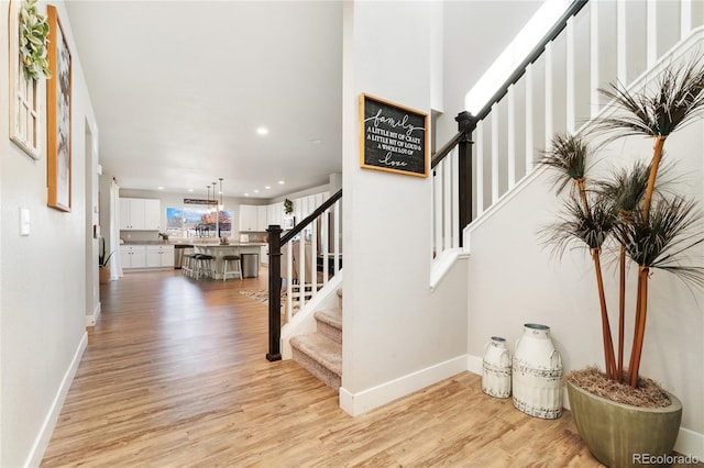 staircase with hardwood / wood-style flooring