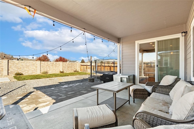 view of patio / terrace with a trampoline and an outdoor living space