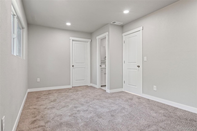 unfurnished bedroom with light colored carpet