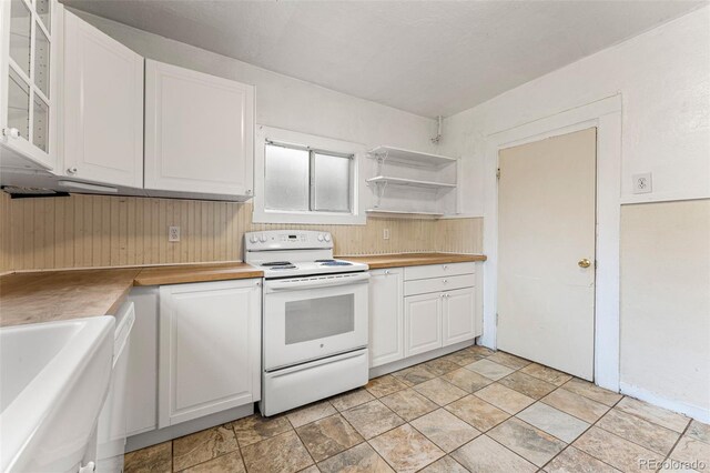 2515 Ames St, Edgewater, CO 80214 - kitchen with white electric range, white cabinets, glass insert cabinets, a sink, and stone finish flooring