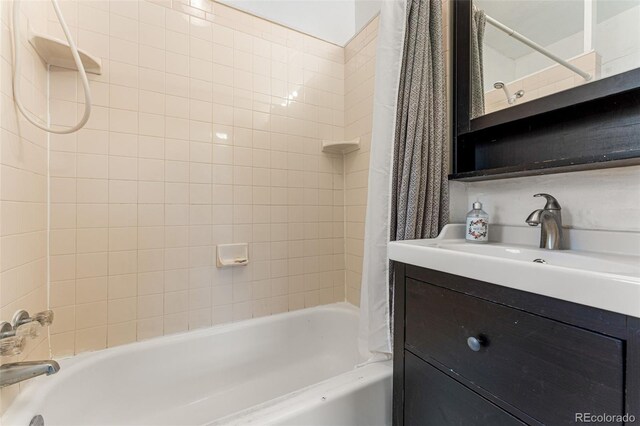 2515 Ames St, Edgewater, CO 80214 - bathroom featuring shower / bathtub combination with curtain and vanity