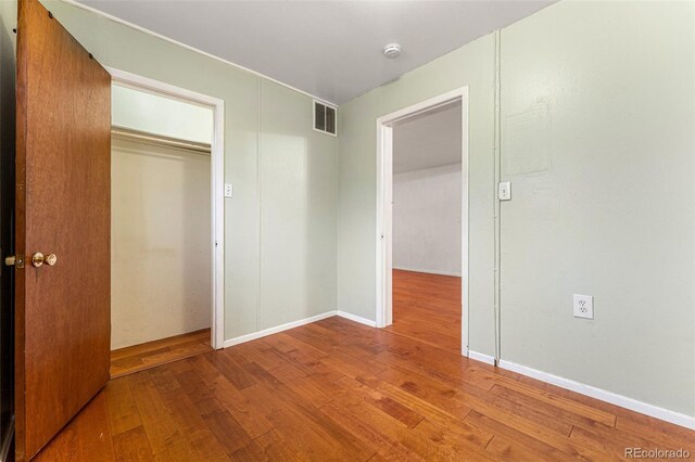 2515 Ames St, Edgewater, CO 80214 - unfurnished bedroom featuring wood finished floors, a closet, and baseboards