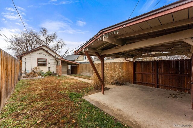 2515 Ames St, Edgewater, CO 80214 - fenced backyard with a carport and a patio area