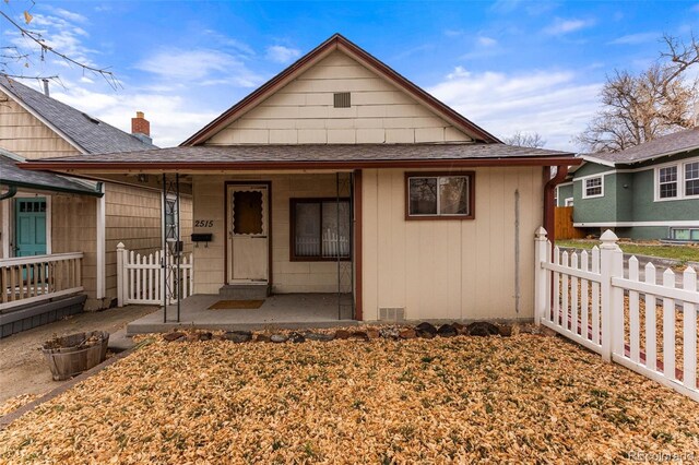 2515 Ames St, Edgewater, CO 80214 - view of front facade featuring a porch and a shingled roof