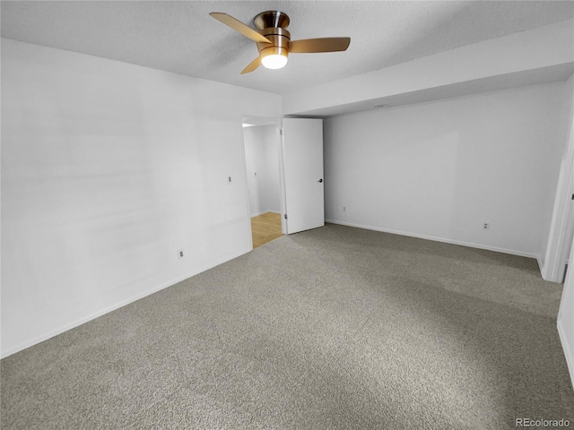 unfurnished room with ceiling fan and carpet flooring