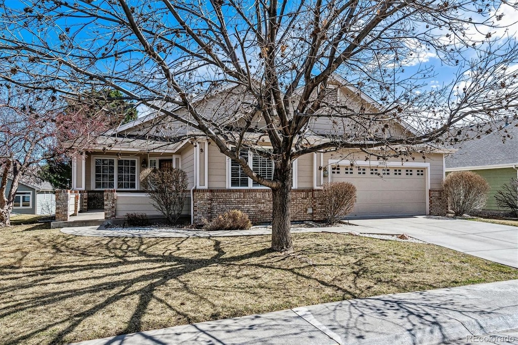 view of front of house with concrete driveway, an attached garage, and brick siding