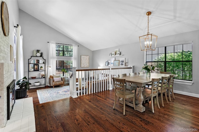 7968 S Trenton St, Centennial, CO 80112 - dining space with a chandelier, wood finished floors, high vaulted ceiling, and a brick fireplace