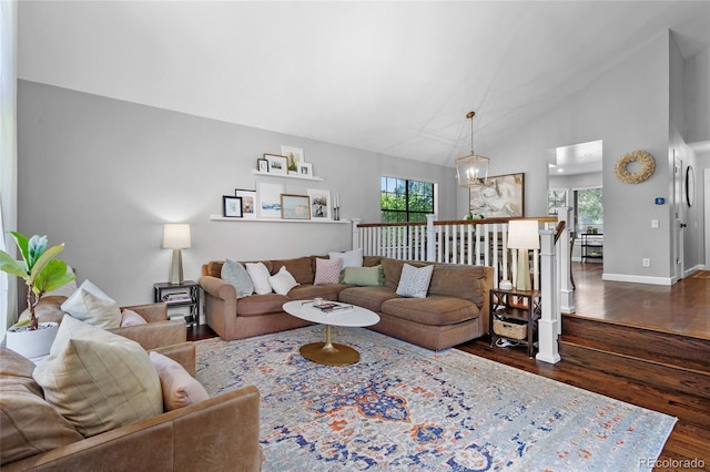 7968 S Trenton St, Centennial, CO 80112 - living room featuring dark wood-style floors, a chandelier, and high vaulted ceiling