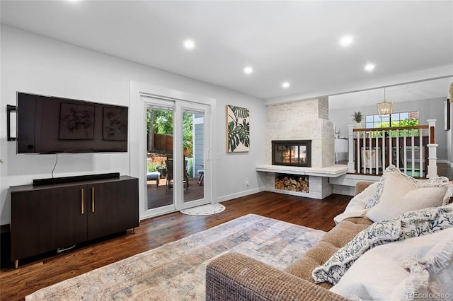 7968 S Trenton St, Centennial, CO 80112 - living room featuring healthy amount of natural light, wood finished floors, recessed lighting, a large fireplace, and a chandelier