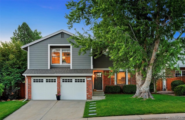 7968 S Trenton St, Centennial, CO 80112 - view of front of house with brick siding, driveway, a garage, and a shingled roof