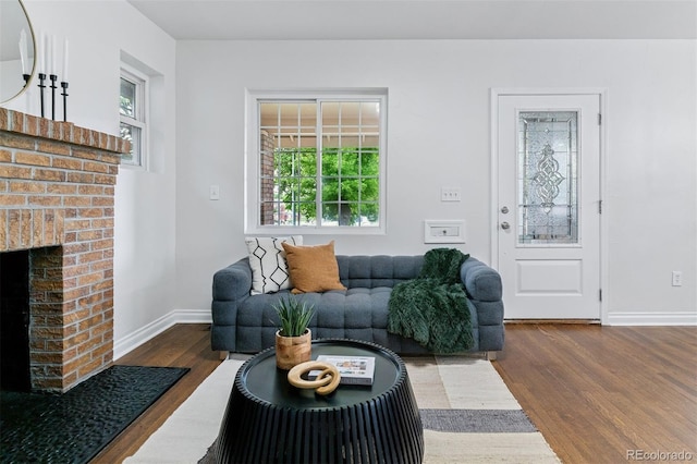4003 Federal Blvd, Denver, CO 80211 - living room with dark wood finished floors, healthy amount of natural light, a brick fireplace, and baseboards