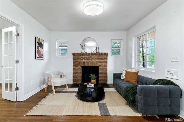 4003 Federal Blvd, Denver, CO 80211 - living room featuring wood finished floors, a fireplace, healthy amount of natural light, and baseboards