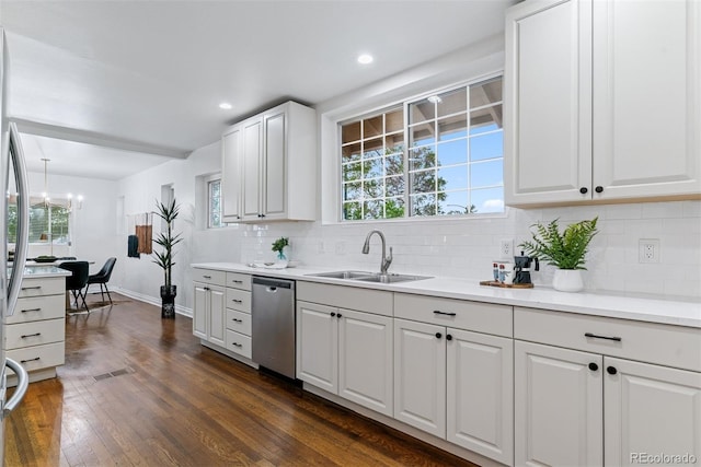 4003 Federal Blvd, Denver, CO 80211 - kitchen with dishwasher, a sink, decorative backsplash, a chandelier, and dark wood-type flooring