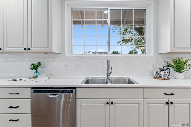 4003 Federal Blvd, Denver, CO 80211 - kitchen featuring stainless steel dishwasher, a sink, white cabinets, and tasteful backsplash
